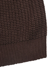 Macro detail of dark coffee waffle knit fabric with ribbed hem on women's sweater