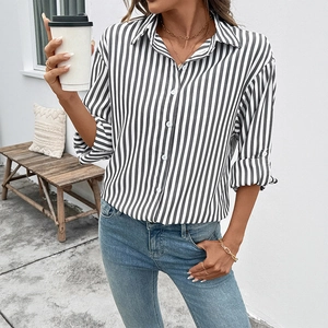Women's vertical black and white striped button-down shirt with long sleeves and collar