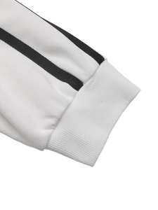 Close-up of white sweatshirt ribbed cuffs with two parallel black athletic stripes