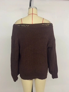 Detail of dark brown off-shoulder knit sweater featuring stylish leopard print bow accents