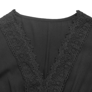 Detailed view of the elegant deep V-neckline with delicate lace trim on a black dress