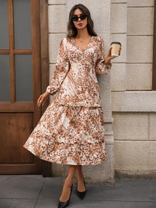 Detail of V-neck printed dress showing ruffled tiered hem and abstract leopard pattern