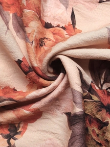 Macro shot of vintage floral print fabric with subtle texture and soft drape detail