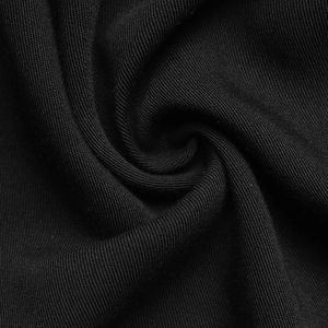 Close-up of premium black knitted fabric showing soft texture and high-density weave