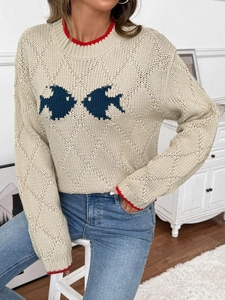 Détail du pull en maille montrant le liseré rouge et le motif de poissons contrastés