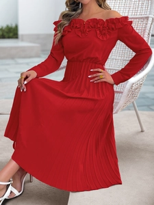 Detail of red off-shoulder dress featuring layered ruffles and pleated chiffon skirt