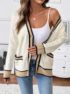 Detail of loose knit cardigan with classic color-block stripe trim and ribbed texture