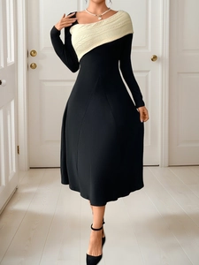 Detail of elegant two-tone dress with cream cable knit patchwork and black slim skirt