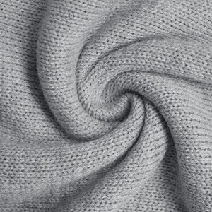 Detailed close-up of light gray chunky knit texture with premium braided pattern