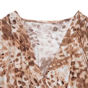 Detail of the V-neckline on a leopard print dress showing fabric texture and stitching