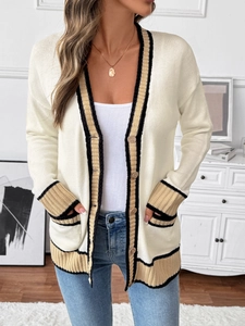 Detailed view of cream knit cardigan with contrast stripes and retro wooden buttons