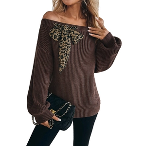 Brown off-shoulder knit sweater with a large leopard print bow on the shoulder