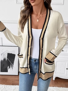 Detailed close-up of a knit cardigan with contrast stripes on cuffs and buttons