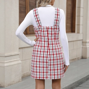 Back view of a red and white plaid tweed pinafore dress with wide straps and short length