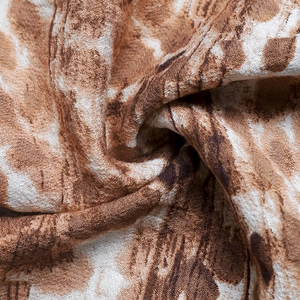 Close-up of lightweight brown and white abstract print fabric with woven texture