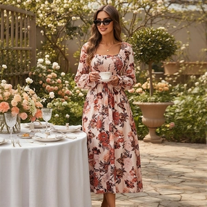 Elegant French floral midi dress with square neck and long sleeves in a garden setting