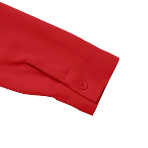 Detail shot of the solid red dress sleeve featuring a matching button and neat stitching