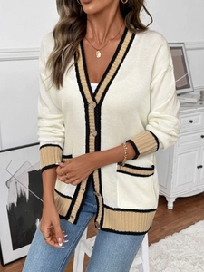 Detail of V-neck knitted cardigan showing contrasting color stripes and ribbed texture
