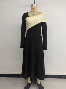 Detail of elegant black dress showing creamy knit texture and patchwork contrast design