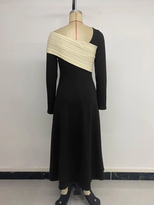 Detail view of contrast knit texture and elegant color-block stitching on long-sleeve dress