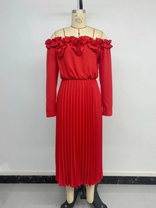 Macro detail of red off-shoulder long sleeve dress with elegant ruffles and pleated skirt