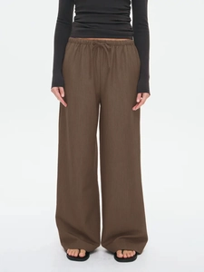 Deep brown wide-leg trousers featuring a drawstring elastic waist and vertical texture