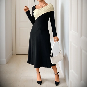 Elegant long-sleeved midi dress featuring black A-line skirt and cream color-block knit detail