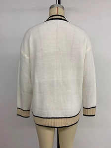 Rear view of loose fit white knit cardigan with contrasting black and beige striped trims