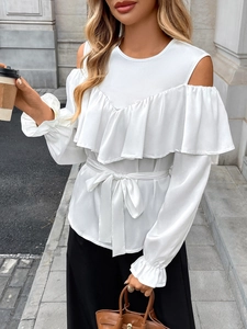 Detail of white off-shoulder chiffon blouse with ruffles and waist tie for women