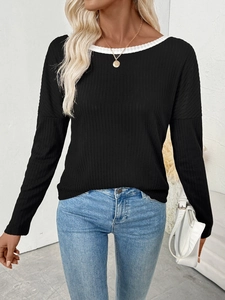 Close-up of black ribbed long-sleeved top with white contrast neckline and slim fit