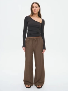Detailed view of women's dark brown wide leg pants with elastic drawstring waist design