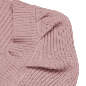 Close-up of pink ribbed knit texture and lapel collar stitching on a party dress