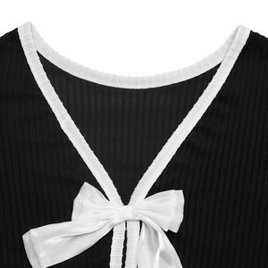 Detail of black ribbed knit sweater with white trim and a satin bow on the back