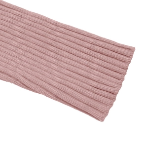 Detail view of pink ribbed knit fabric showing fine texture and cuff craftsmanship