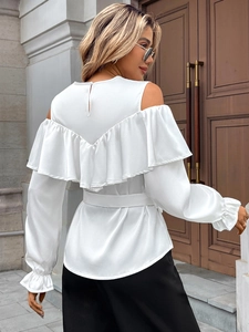 Detail of white off-shoulder shirt showing ruffle layers and adjustable waist tie