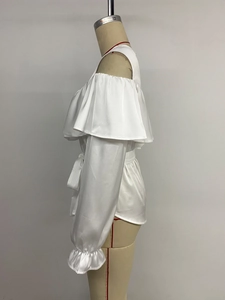 Detail view of white ruffled off-shoulder satin blouse with elegant waist tie and pleats