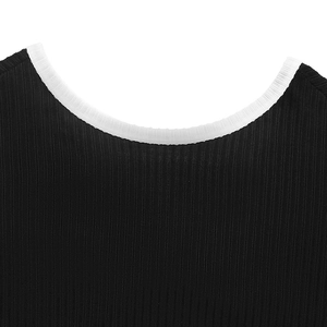 Close-up of the ribbed knit black fabric and white crew neck piping details on the top