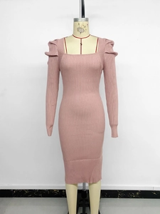 Detail of pink knit dress showing square neckline and elegant puffed sleeve texture