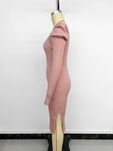 Detail of pink ribbed knit midi dress featuring puff sleeves and a stylish side slit