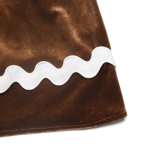 Détail macro du tissu en velours marron avec dentelle ondulée blanche et couture nette