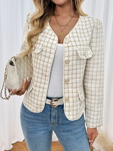 Detail of tweed texture jacket with pearl trim and gold buttons in beige pattern