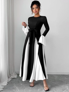 Close-up of contrast flare sleeves and bow tie detail on a monochrome A-line dress