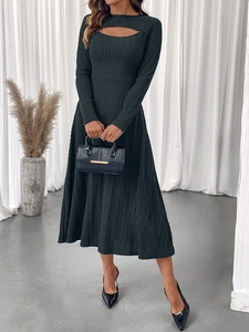 Detail of elegant knit dress featuring chest cut-out and ribbed texture on the fabric
