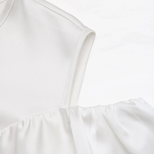 Detailed view of the elegant white satin shirt neck and ruffled stitching texture