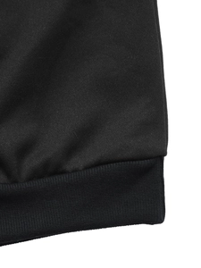 Detail of black knitted sweatshirt showing ribbed cuffs and neat stitching craftsmanship