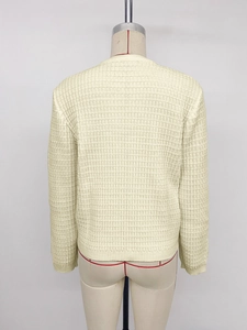 Detailed back view of a cream-colored knit cardigan with 3D textured waffle pattern