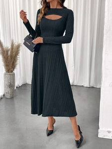 Detail of elegant black knit midi dress featuring a cutout neckline and ribbed texture