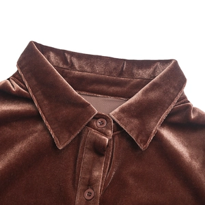 Detail view of the brown velvet shirt collar with matching buttons and smooth texture
