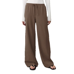 Brown wide-leg drawstring trousers with elastic waist and casual cotton linen texture