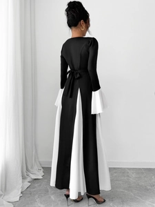 Detail of elegant back bow tie and white color-block contrast on a long black dress